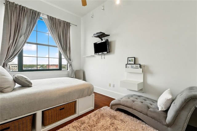 bedroom with ceiling fan, wood-type flooring, and vaulted ceiling