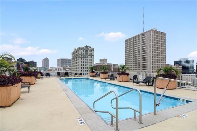community pool featuring a view of skyline and a patio