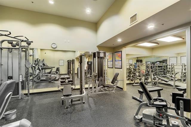 gym with a towering ceiling