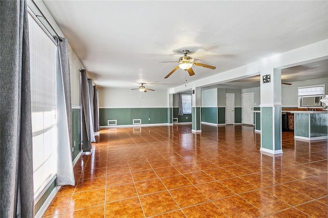 spare room with dark tile patterned flooring and ceiling fan