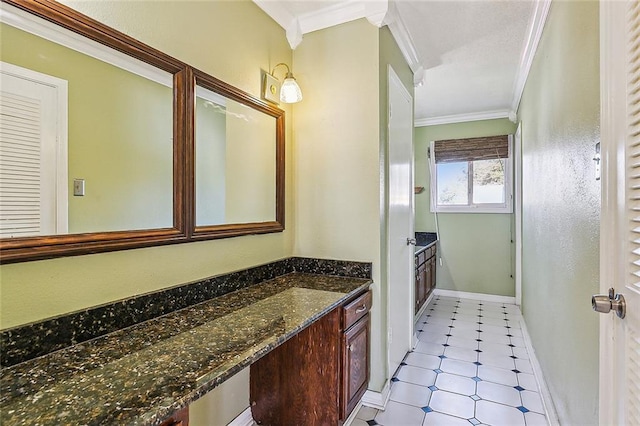 bathroom featuring ornamental molding and vanity