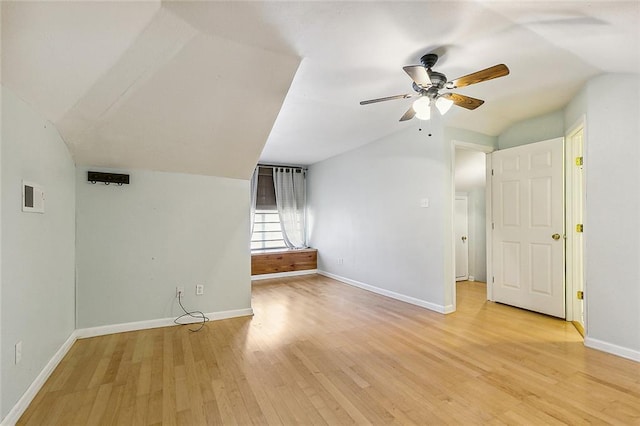 empty room featuring vaulted ceiling, ceiling fan, and light wood-type flooring