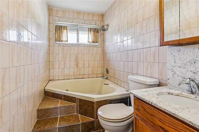 full bathroom with vanity, tiled shower / bath, tile walls, and toilet