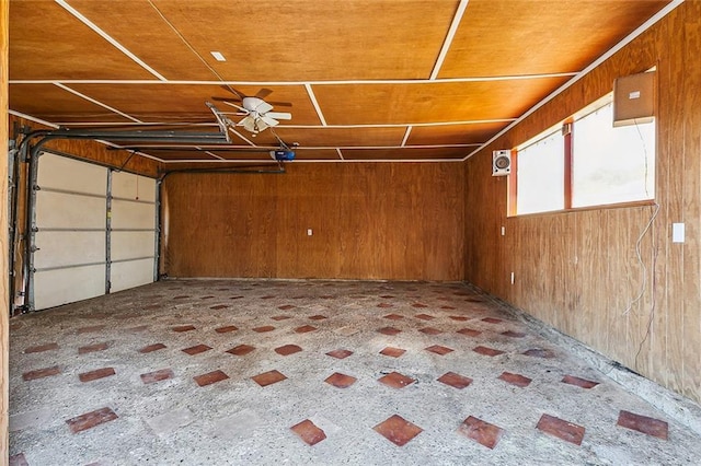 garage with a garage door opener and wooden walls