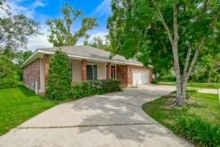 view of front of home featuring a garage and a front lawn