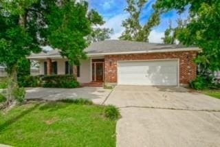 view of front of property featuring a garage and a front lawn