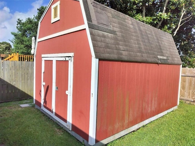 view of outbuilding featuring a lawn