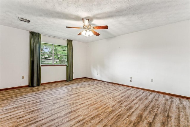 116 Villary St, Belle Chasse, LA 70037 - empty room featuring wood finished floors, a ceiling fan, baseboards, and a textured ceiling