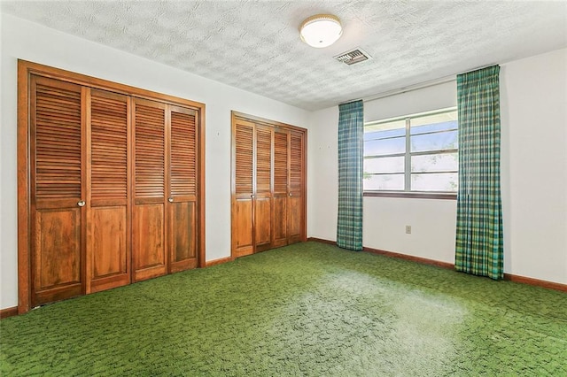 116 Villary St, Belle Chasse, LA 70037 - unfurnished bedroom with carpet floors, multiple closets, baseboards, and a textured ceiling