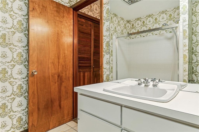 116 Villary St, Belle Chasse, LA 70037 - bathroom with wallpapered walls, vanity, a shower, and tile patterned floors