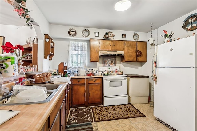 kitchen featuring white appliances and sink