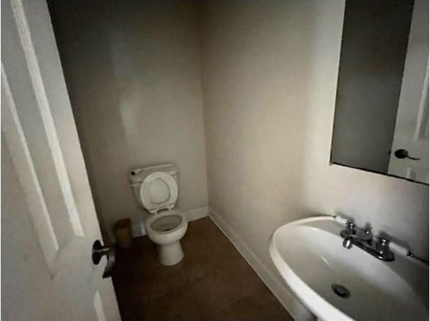 bathroom with sink, tile patterned flooring, and toilet