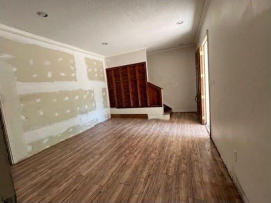 interior space featuring ornamental molding and wood-type flooring