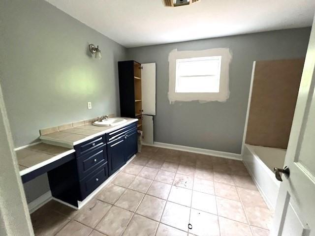 bathroom with vanity, shower / tub combination, and tile patterned flooring