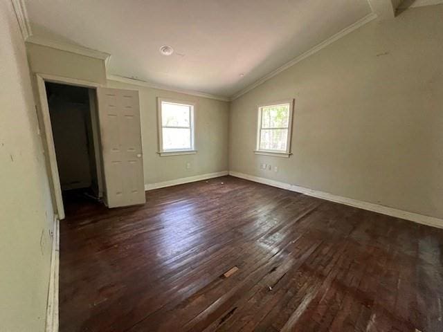 unfurnished bedroom with crown molding, dark hardwood / wood-style floors, and lofted ceiling