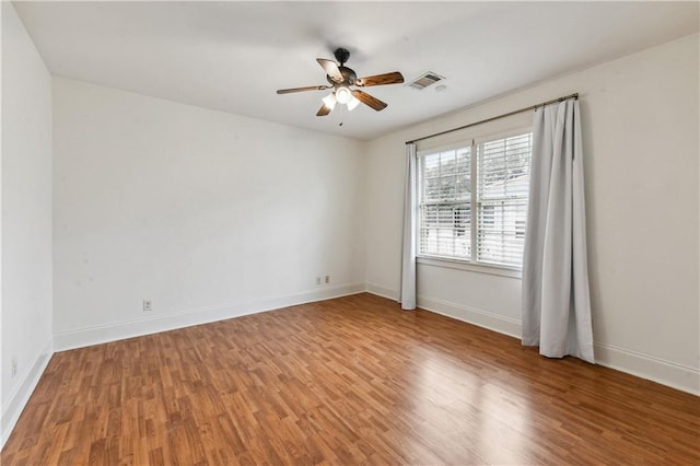 unfurnished room with ceiling fan and hardwood / wood-style flooring