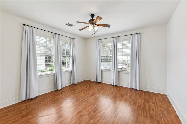 spare room with wood-type flooring and ceiling fan