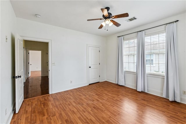 unfurnished bedroom with ceiling fan and hardwood / wood-style floors