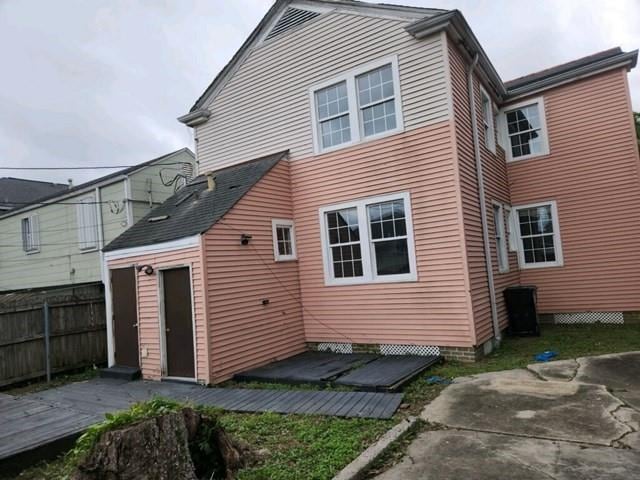 rear view of house with fence and a patio