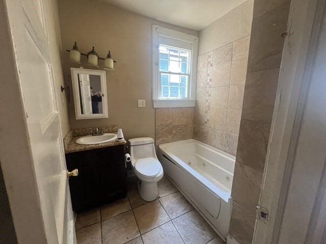 full bathroom with vanity, tiled shower / bath combo, toilet, and tile patterned floors