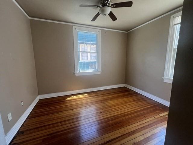 unfurnished room with a ceiling fan, baseboards, ornamental molding, and wood finished floors