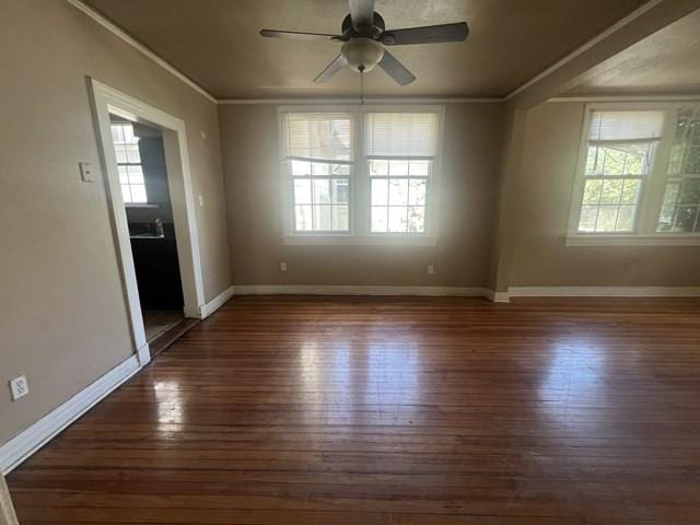 spare room featuring ceiling fan, dark hardwood / wood-style floors, and ornamental molding