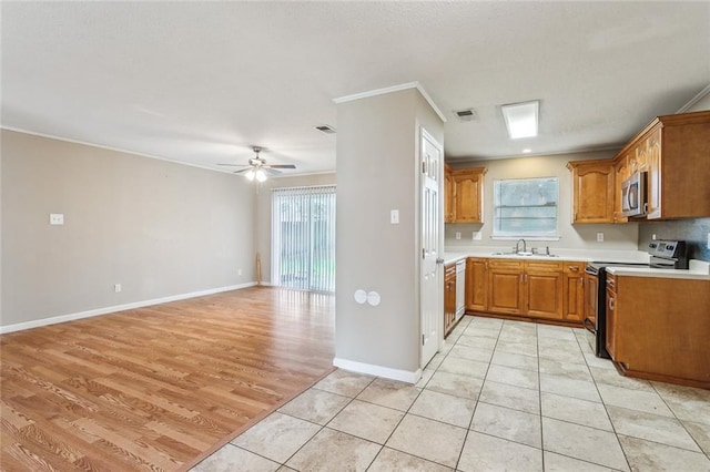 kitchen with light tile patterned flooring, crown molding, dishwasher, range with electric cooktop, and ceiling fan