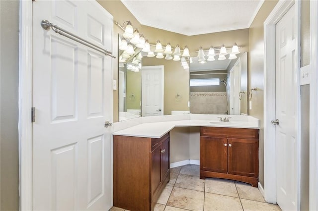 bathroom with crown molding, vanity, and tile patterned flooring