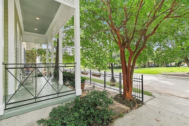 view of patio / terrace with a porch and fence