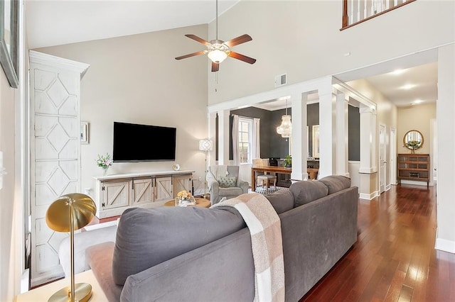 living room featuring high vaulted ceiling, dark hardwood / wood-style floors, and ceiling fan with notable chandelier