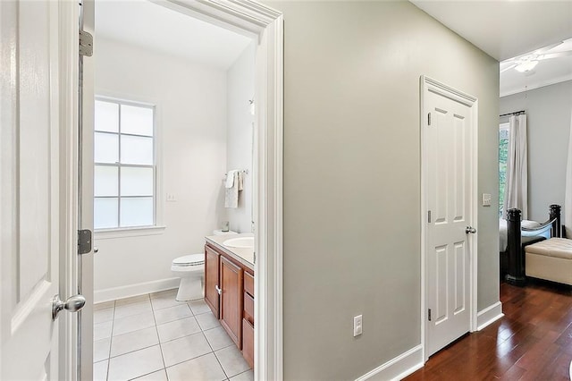 bathroom with tile patterned flooring, toilet, vanity, and baseboards