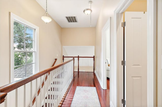 corridor with dark hardwood / wood-style flooring