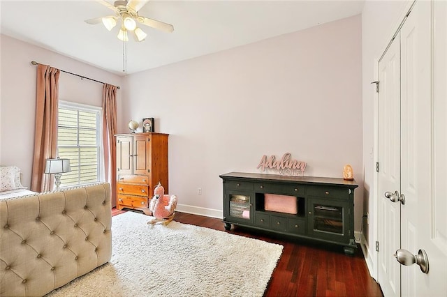 bedroom with a closet, ceiling fan, and dark wood-type flooring