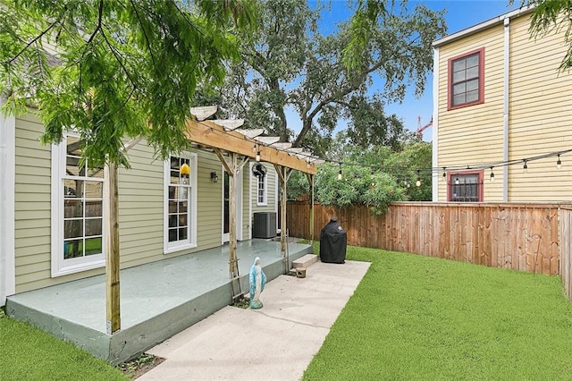 view of yard featuring a pergola, central air condition unit, and a patio