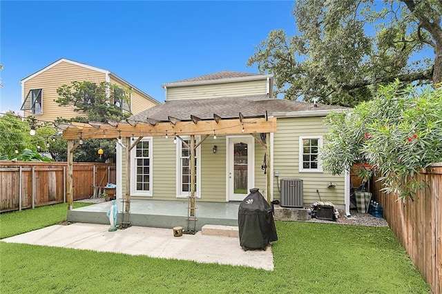 rear view of property featuring a patio, cooling unit, a yard, a fenced backyard, and a pergola