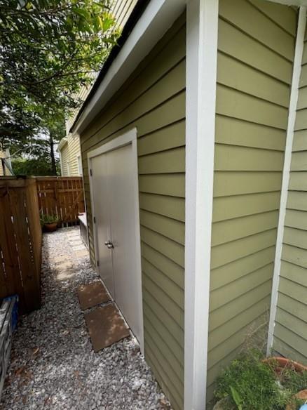 view of outbuilding with fence