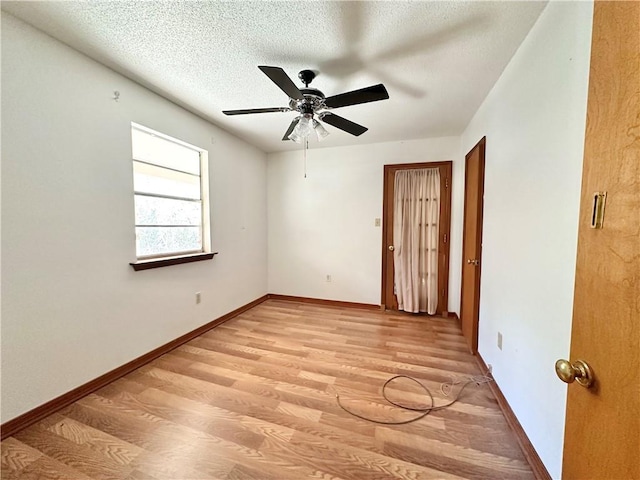 unfurnished bedroom with ceiling fan, a textured ceiling, and light hardwood / wood-style flooring