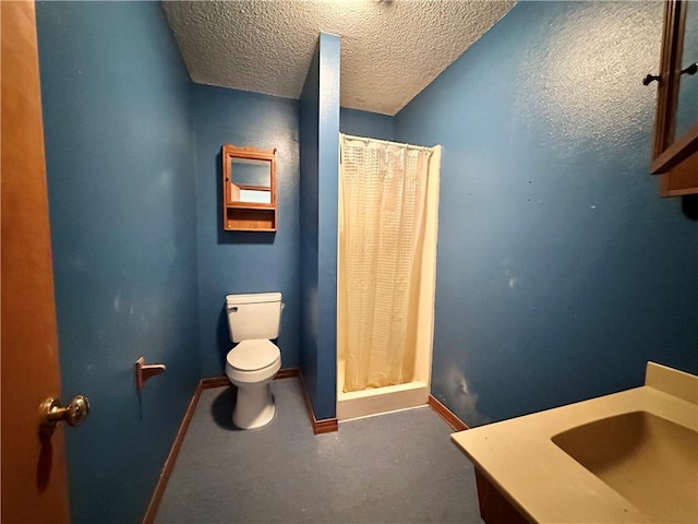 bathroom featuring a textured ceiling, toilet, concrete flooring, vanity, and curtained shower