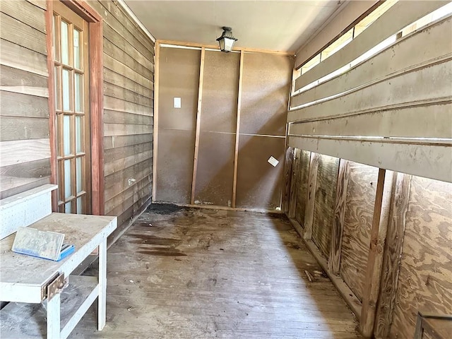 interior space featuring wood walls and dark hardwood / wood-style floors