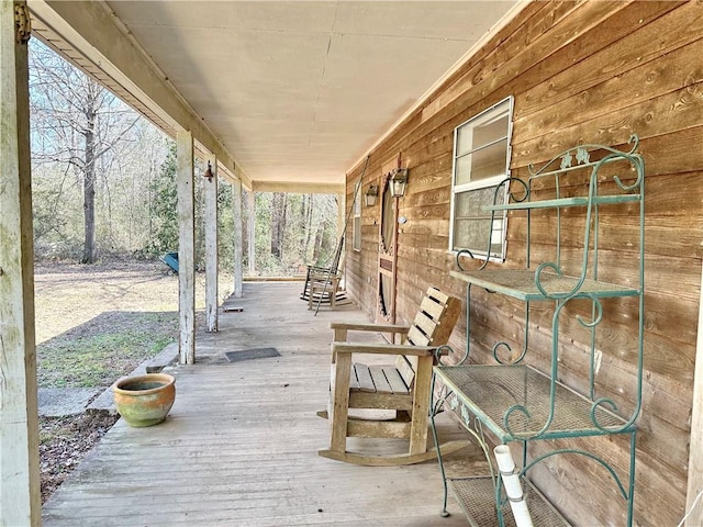 wooden terrace featuring covered porch