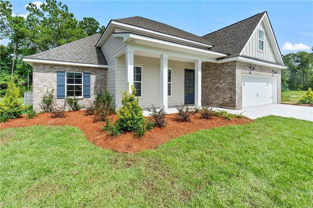 view of front of house with brick siding, a shingled roof, a front yard, and concrete driveway
