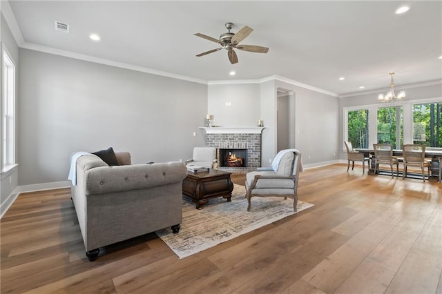 living area with recessed lighting, visible vents, and wood finished floors