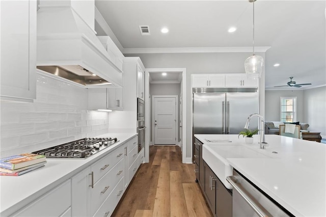 kitchen featuring appliances with stainless steel finishes, light countertops, ceiling fan, visible vents, and crown molding