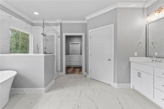 bathroom featuring vanity, a marble finish shower, marble finish floor, a freestanding bath, and baseboards