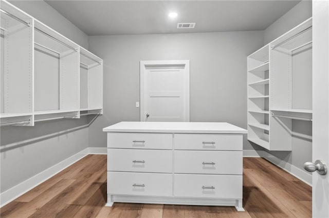 walk in closet featuring hardwood / wood-style floors