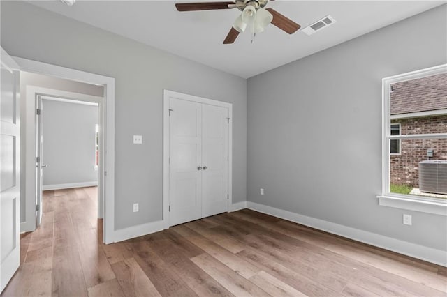 unfurnished bedroom with a closet, ceiling fan, and light wood-type flooring