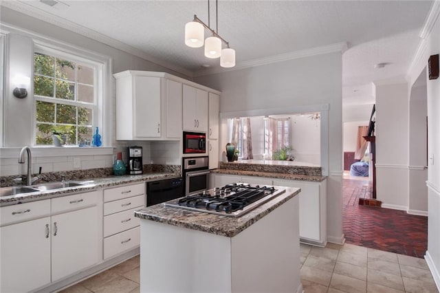 kitchen featuring sink, a kitchen island, stainless steel appliances, white cabinets, and light tile patterned flooring