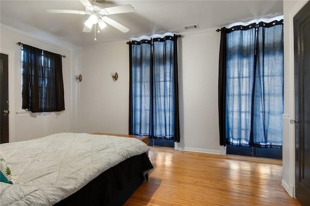 bedroom featuring ornamental molding, ceiling fan, and light hardwood / wood-style floors