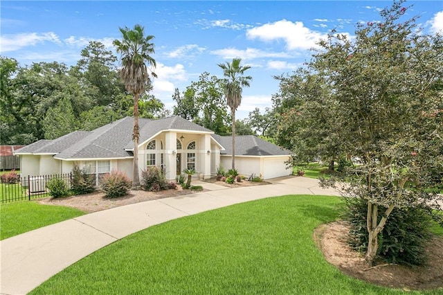 view of front of property with a garage and a front yard