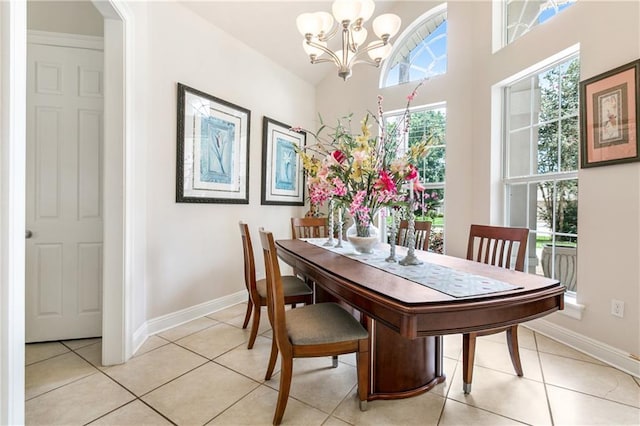 dining room with light tile patterned floors and a chandelier